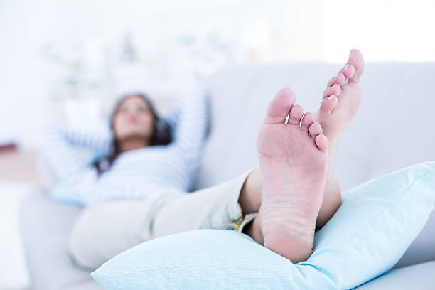 istock Smiling beautiful brunette relaxing on the couch 484105810