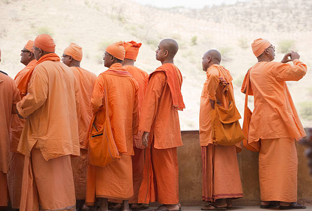 Jaipur, India - March 18, 2014: A group of Indian buddhist monks on vacation are visiting and taking photos in Amber Fort. Anyone who has camera sees different than others.