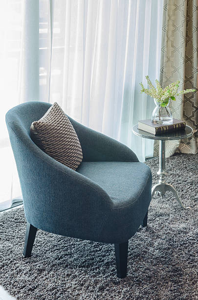 istock modern blue chair with brown pillow on carpet 484108218