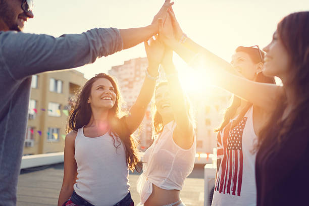 istock Happy friends at the rooftop doing high five 484108376