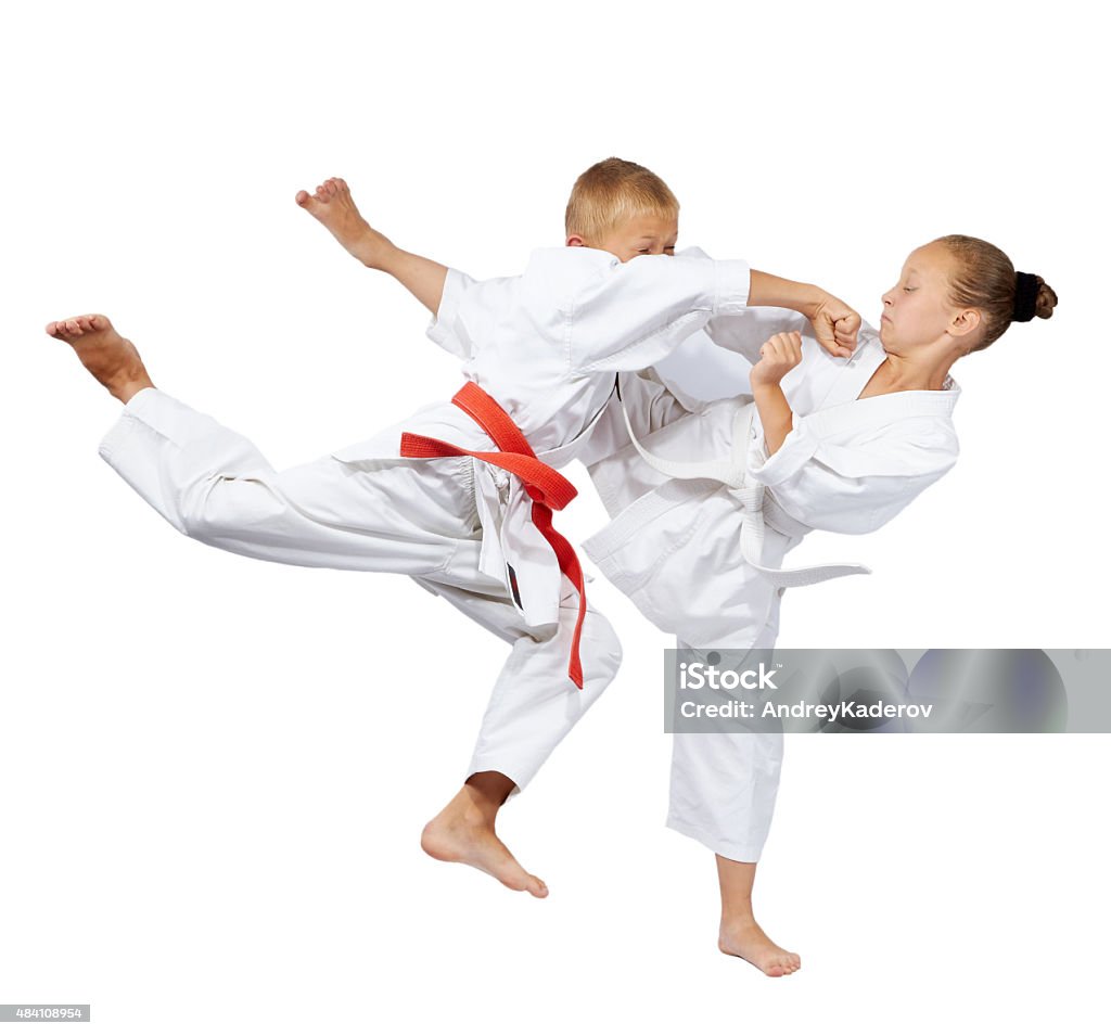 Punch in the jump and kick leg are beating sportsmens Punch in the jump and kick leg are beating the sportsmens in karategi 2015 Stock Photo