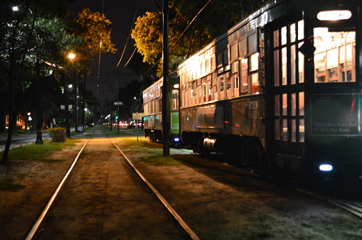 Night time view of street cars on St Charles Avenue in New Orleans Louisiana.