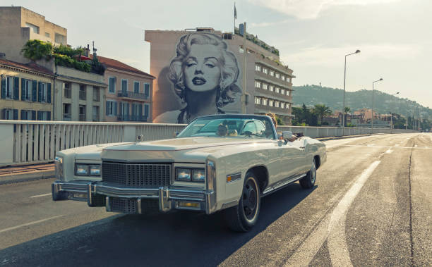 Boulevard d'Alsace, Cannes, French Riviera Cannes, France - August 10, 2015: The mural dedicated to Marilyn Monroe photographed when a car with two tourists walked Boulevard d'Alsace. In Cannes, there are many murals dedicated to actors and directors for the famous International Film Festival that takes place every year in May. mural photos stock pictures, royalty-free photos & images