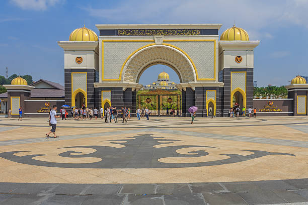 Malaysian Royal Palace Kuala Lumpur, Malaysia - August 16, 2013: View of the  New Royal Palace Istana Negara (national palace) with people in front of the main gate istana stock pictures, royalty-free photos & images
