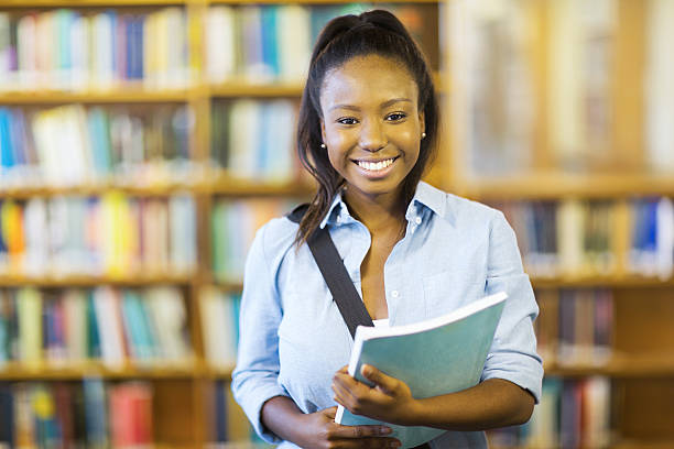 istock female african college student holding a book 484115832