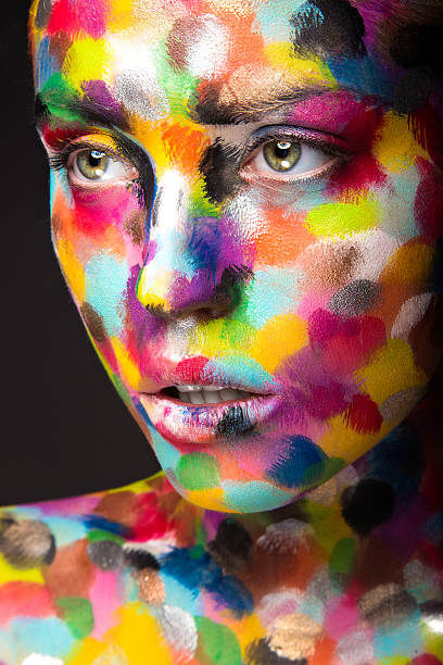 istock Girl with colored face painted. Art beauty image 484115918