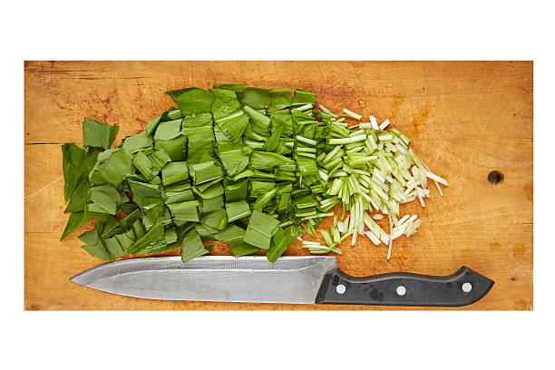 cutted wild garlic cutted wild garlic (Allium ursinum) on wood board isolated on white zigeunerlauch stock pictures, royalty-free photos & images