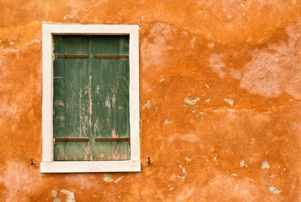 Green shutters on Orange Wall stock photo