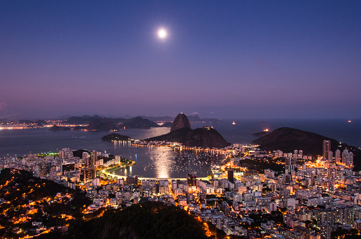 Night View of Sugarloaf Mountain and Botafogo Neighborhood in Rio de Janeiro with Moon Shining in the Sky