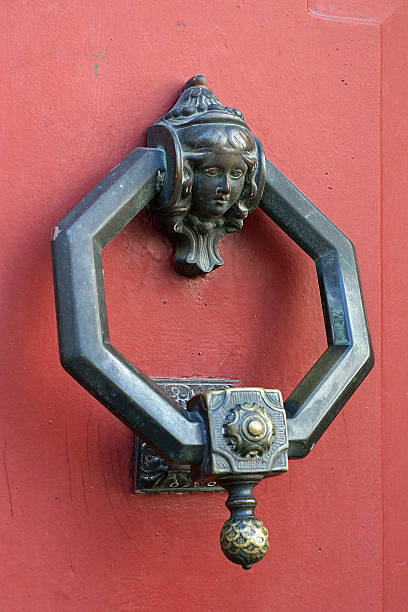 istock copper doorknocker on red door 484122782