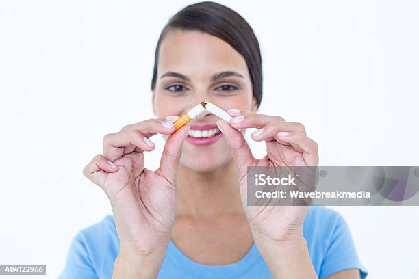 Happy Woman Breaking A Cigarette Stock Photo - Download Image Now - 20-24 Years, 20-29 Years, 2015