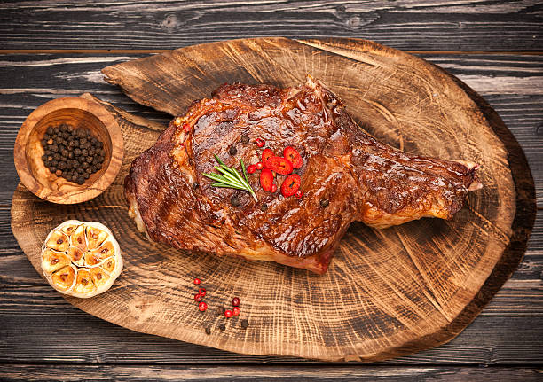 istock Grilled steak on wooden board 484124480