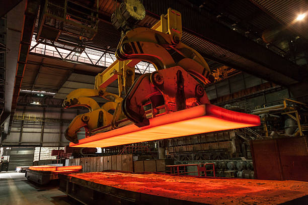 Steel swife is loaded A glowing steel slab is loaded in the steelworks foundry photos stock pictures, royalty-free photos & images