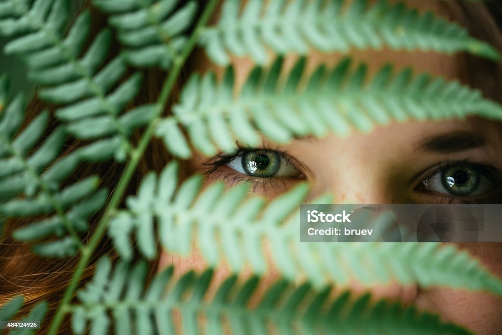 Portrait Of a Smiling Happy Beauty Girl Holding Leaf Fern Close Up Portrait Of a Smiling Young Happy Beauty Red Hair Girl Holding Leaf Up To Face In Summer Park Forest Leaf Stock Photo