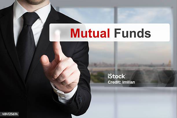 Businessman Pushing Touchscreen Button Mutual Funds Stock Photo - Download Image Now