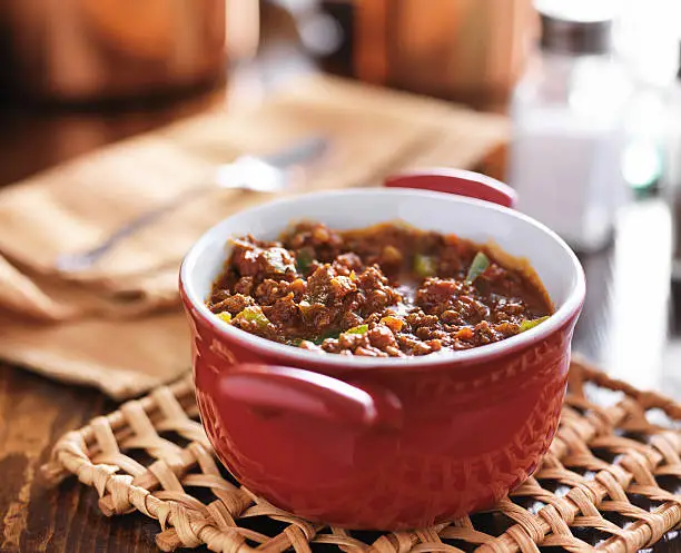 Photo of red dish with meaty beef chili and bell peppers