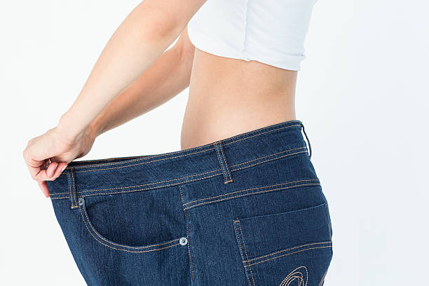 istock Woman belly in too big pants 484133980
