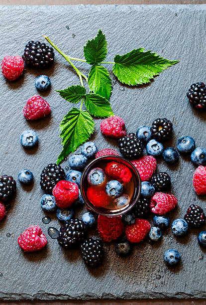 istock Juice of wild berries on a dark background 484134120