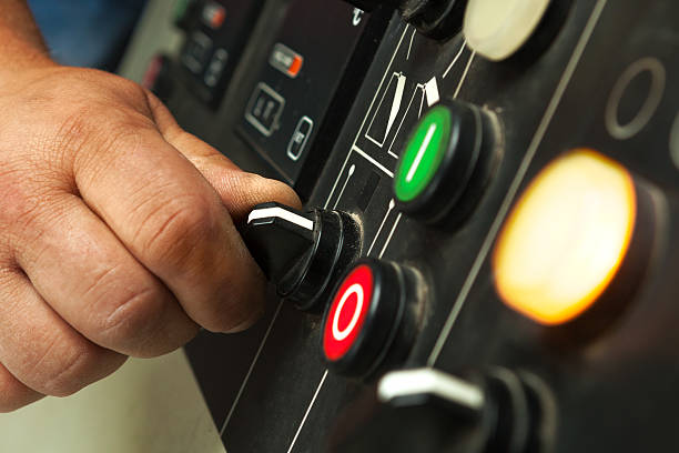 istock Male hand operating switches and buttons. 484134596