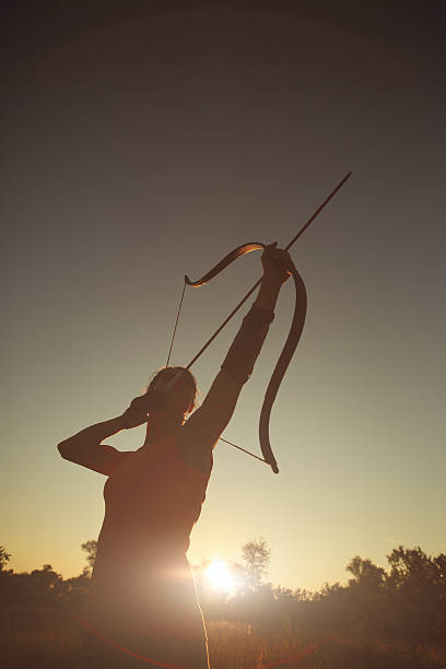istock Female archer in the field at sunset 484137458