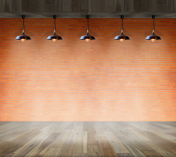 istock Lamp at brick wall background with ground wood 484138436