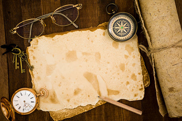 istock Old paper, compass, pocket watch on wooden background 484138582