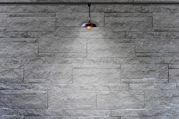 istock Granite stone decorative brick wall with lamp 484138758