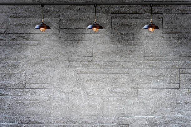 istock Granite stone decorative brick wall with lamp 484138762