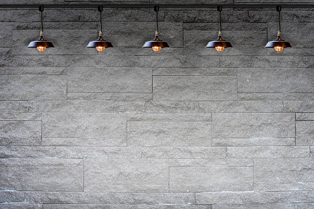 istock Granite stone decorative brick wall with lamp 484138764