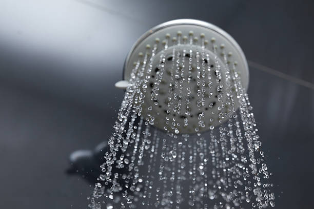 istock shower head in bathroom with water drops flowing 484148122