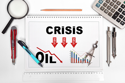 notepad with oil crisis chart on desktop engineer