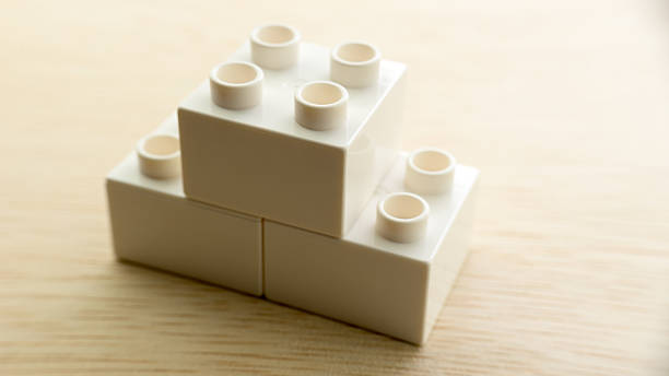 istock White colour plastic building blocks on wooden surface 484149378