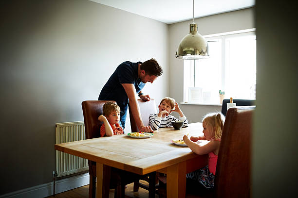 istock Father with his three children eating lunch 484150142