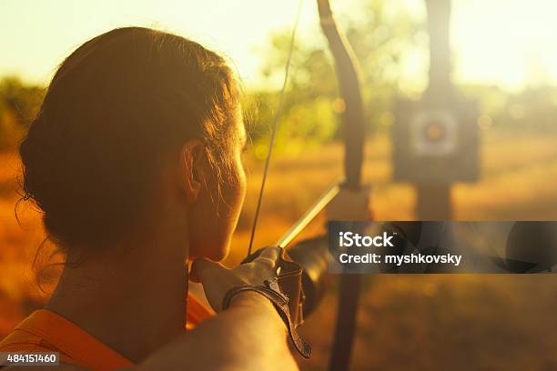 Female Archer In The Field At Sunset Stock Photo - Download Image Now - Archery, Sports Target, Aspirations