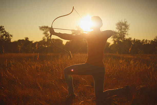 istock Female archer in the field at sunset 484151502