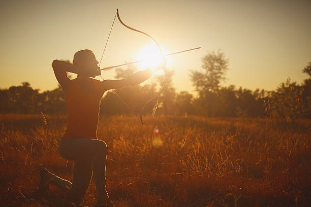 istock Female archer in the field at sunset 484151514