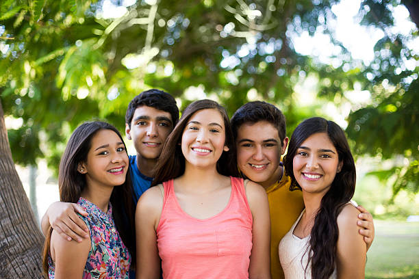 istock Happy Hispanic friends enjoying in park 484151728