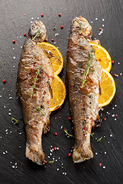 istock Baked trout fish with orange and thyme 484151862