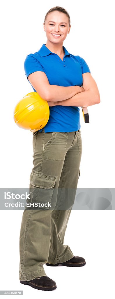 Woman Contractor Construction Worker on White Twenty-something pretty woman with hardhat and level wearing blue polo shirt, green cargo pants, workboots isolated on white background Polo Shirt Stock Photo