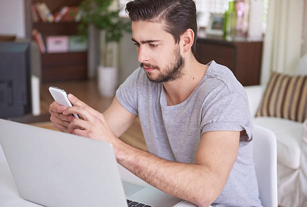 istock Pensive man working on his smartphone and laptop 484154676