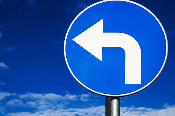 road sign turn left against the sky