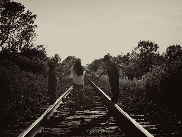 istock Kids Walking Railroad Tracks 484155086