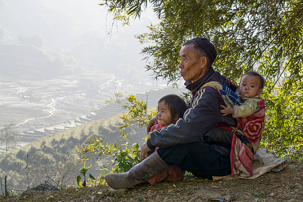 Sapa, Vietnam - January 22, 2015: Local Vietnamese Hmong family in the mountain region of Sapa. The Hmong are a ethnic tribal group that live in the mountainous areas of Vietnam, China, Laos and Thailand. The tribe is famous for their colourful cloth and clothing.