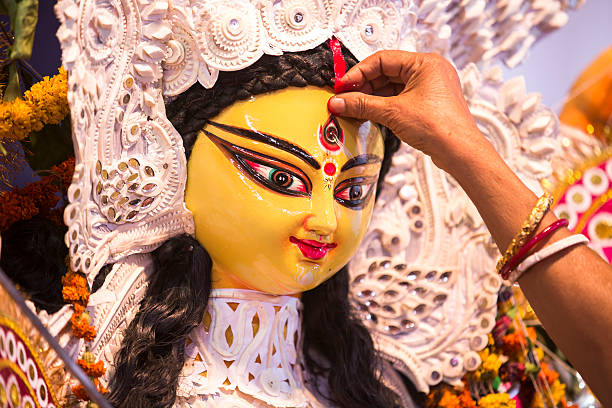 Indian Deity : Goddess Durga during Durga Puja festival An Indian Deity : Goddess Durga during Durga Puja festival. Ladies bidding adieu to the mother Goddess on the last day of the festival , before immersion in a river.  Durga worship is a yearly event and these deities are created every year and immersed in a river every year after the completion of the 5-day event. The idol is not copyright protected. cat face paint stock pictures, royalty-free photos & images