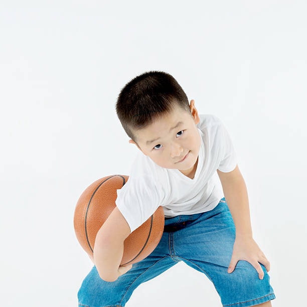 istock Little asian boy holding a basketball 484156016