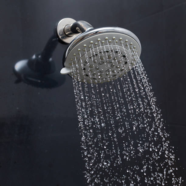 istock shower head with water drops flowing 484156528