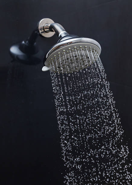 istock shower head with water drops flowing 484156590