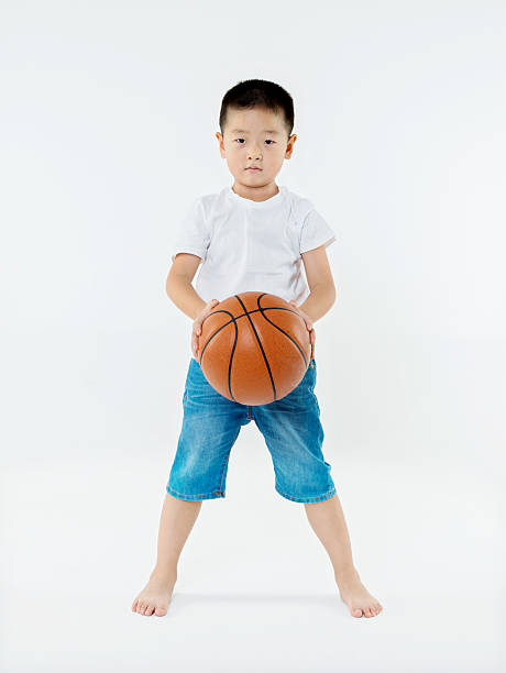 istock Little asian boy holding a basketball 484156604