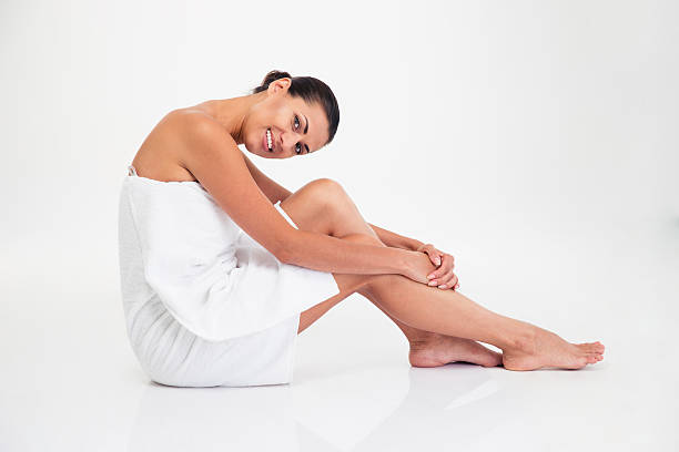 istock Charming woman in towel sitting on the floor 484162418