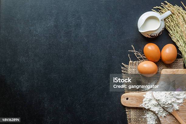 Baking Powder Milk And Eggs On Chalkboard For Background Stock Photo - Download Image Now